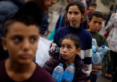 People queue for water in Rafah after Israel cut off water and electricity to Gaza. Reuters
