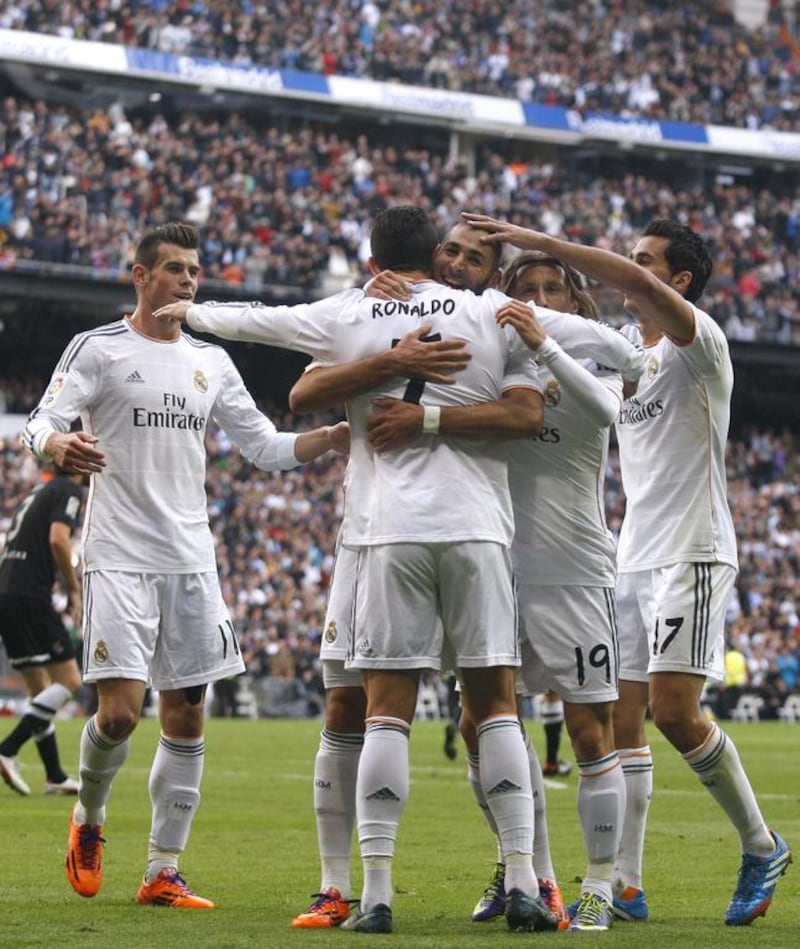Cristiano Ronaldo celebrates with Real Madrid teammates including Karim Benzema, centre, and Gareth Bale, left. Elisa Estrada / Getty Images