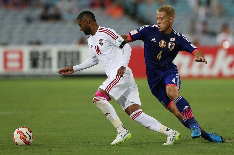 Keisuke Honda of Japan, right, fights for the ball with Abdulaziz Sanqour of the UAE during their Asian Cup quarter-final match on Friday. Craig Golding / AFP