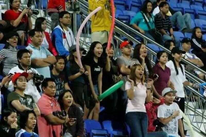 Filipino fans cheer on their country in Dubai last night.