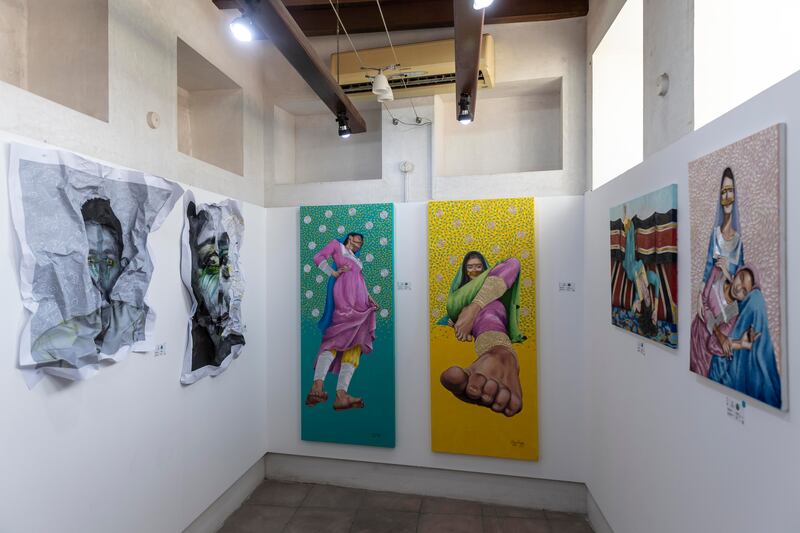 Paintings by Mai Majdy, centre, part of the Round exhibition at Sikka, which includes works by Faisal Al Rais, Moza Al Falasi, Ali Jamal, among others.
