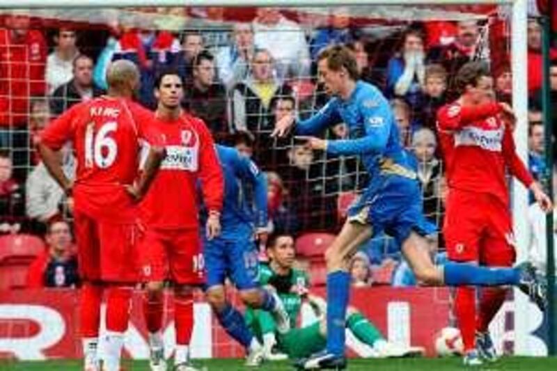 Portsmouth's Peter Crouch (right) celebrates after scoring the first goal as Middlesbrough's players stand dejected