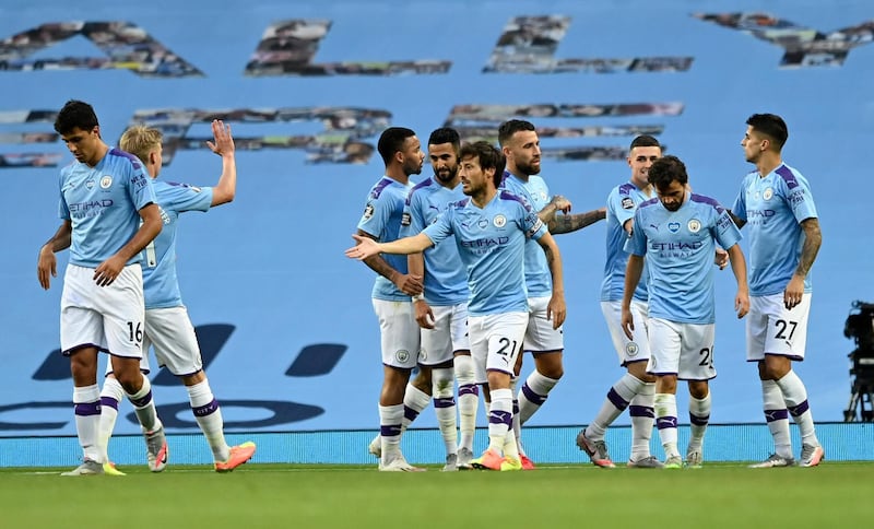 Manchester City's David Silva is congratulated by teammates after scoring his team's fourth goal. AP Photo