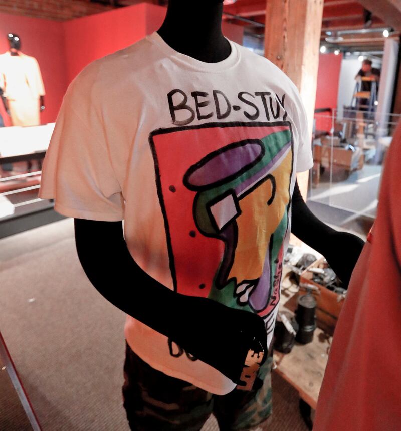 In this photo made on Thursday, Aug. 23, 2018, a T-shirt from the film "Do the Right Thing" is on a mannequin before it is placed in the display at an exhibit of Ruth E. Carter cinematic costumes at Pittsburgh's Senator John Heinz History Center in Pittsburgh. The exhibit that opens Saturday, Aug. 25, explores Carter's groundbreaking career. "Heroes & Sheroes: The Art and Influence of Ruth E. Carter in Black Cinema" showcases over 40 costumes from nine movies. The costumes include those from "Amistad," "What's Love Got to do With It," "The Butler," "Malcolm X," "Selma," "Do the Right Thing" and of course "Black Panther." It is scheduled to run to Dec. 2, 2018. (AP Photo/Keith Srakocic)