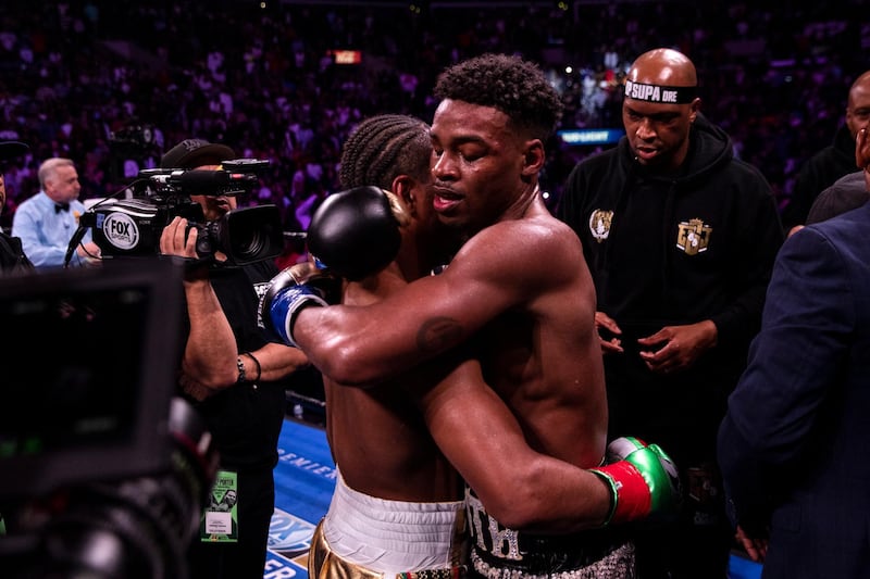 Errol Spence Jr and Shawn Porter embrace at the end of the fight. EPA