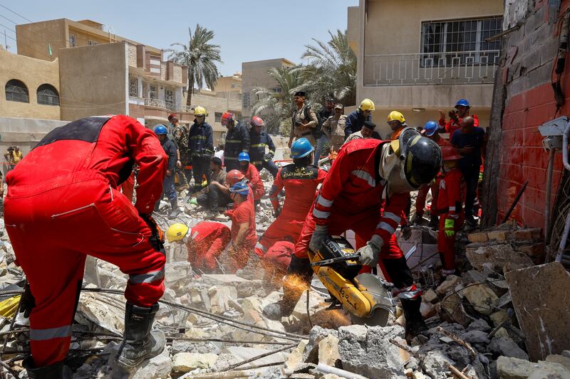 Iraqi Civil Defence workers sift through rubble at the site of the collapse of a fast-food restaurant after an explosion caused by a leak from cooking gas, in Baghdad on Sunday. Reuters