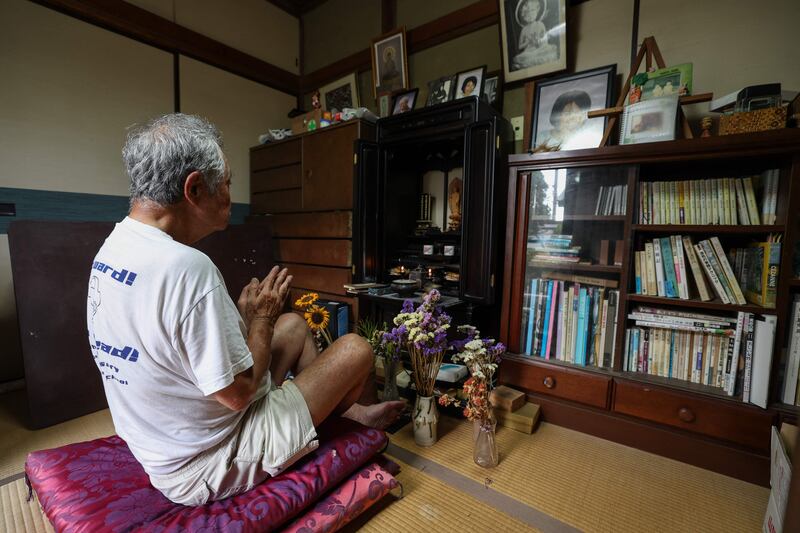 Yasutake Oshima at prayer in his home in suburban Tokyo