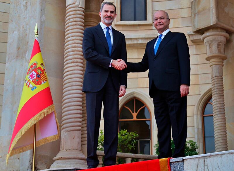 Iraqi President Barham Salih shakes hands with Spain's King Felipe VI in Baghdad, Iraq. AP Photo