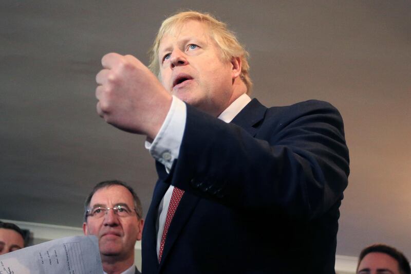 Britain's Prime Minister Boris Johnson, gestures as he speaks to supporters on a visit to meet newly elected Conservative party MP for Sedgefield, Paul Howell, at Sedgefield Cricket Club in County Durham, north east England, Saturday Dec. 14, 2019, following his Conservative party's general election victory.  Johnson called on Britons to put years of bitter divisions over the country's EU membership behind them as he vowed to use his resounding election victory to finally deliver Brexit. (Lindsey Parnaby/Pool via AP)