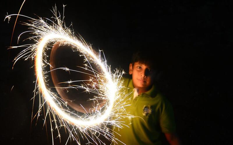 In Sri Lanka, a boy celebrates new year with a sparkler in Colombo.  Lakruwan Wanniarachchi/AFP Photo