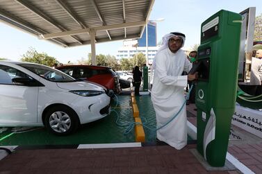 Majid Al Hazami from Dewa charges a car at the electricity authority's headquarters in Garhoud, Dubai in February 2015. The government will allow electric car owners to charge for free until the end of 2021. Pawan Singh / The National