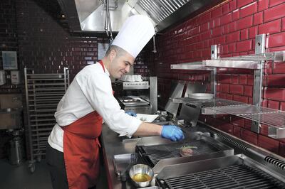 ABU DHABI , UNITED ARAB EMIRATES , APRIL 17   – 2018 :- Daniel Vicente , Chef at the Capital Grill restaurant making the Grill Wagyu Steak with carrot puree and sauce dish at Dusit Thani hotel in Abu Dhabi. ( Pawan Singh / The National ) For Weekend. Story by Melinda Healy