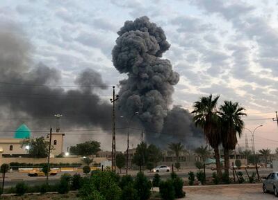 FILE - In this Monday, Aug. 12, 2019 file photo, plumes of smoke rise after an explosion at a military base southwest of Baghdad, Iraq. A fact-finding committee appointed by the Iraqi government to investigate a massive munitions depot explosion near the capital Baghdad has concluded that the blast was the result of a drone strike. A copy of the report was obtained by The Associated Press Wednesday, Aug. 21, 2019. (AP Photo/Loay Hameed, File)