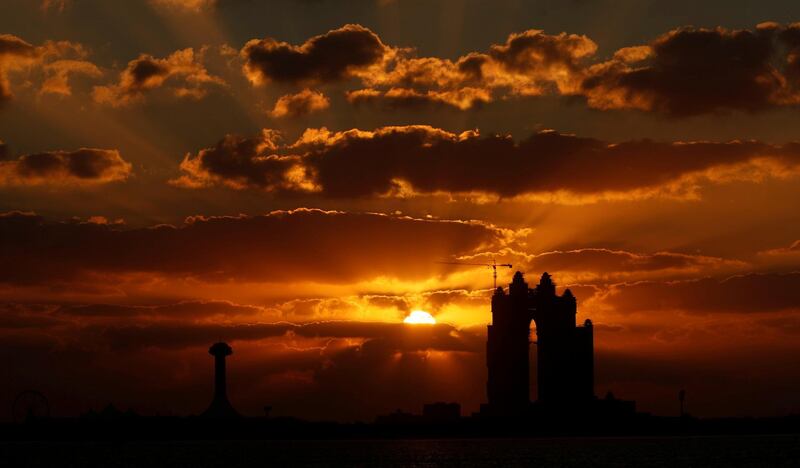 The sun sets behind the Fairmont Hotel in Abu Dhabi, UAE. Matthew Childs / Reuters