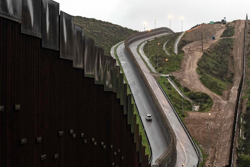 A Border Patrol unit drives near a section of reinforced US-Mexico border fence seen from Tijuana, Baja California state, Mexico.  AFP