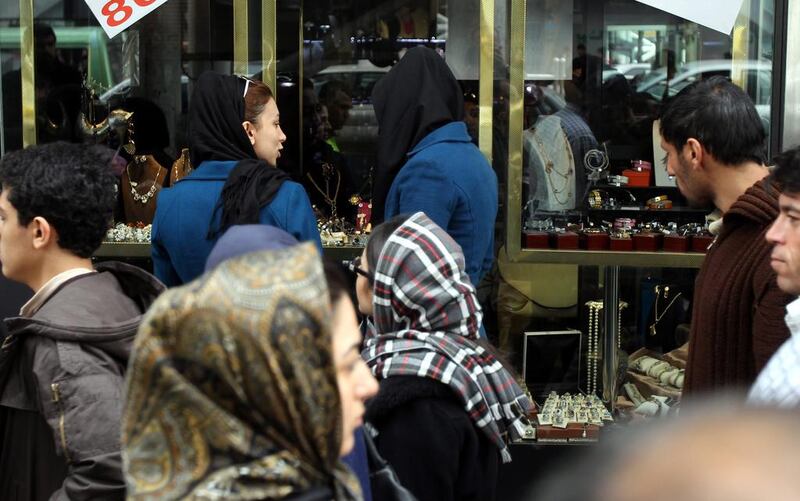 Iranian women are required to wear headscarves and long coats. Abedin Taherkenareh / EPA