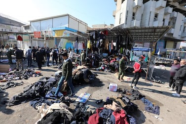 epa08955229 Iraqis clean the site of the second bomb explosion in a central Baghdad used clothes market, Iraq, 21 January 2021. According to local media reports, two bombs exploded in a popular commercial area in central Baghdad on 21 January morning. At least 31 people were killed and dozens were injured. EPA/AHMED JALIL