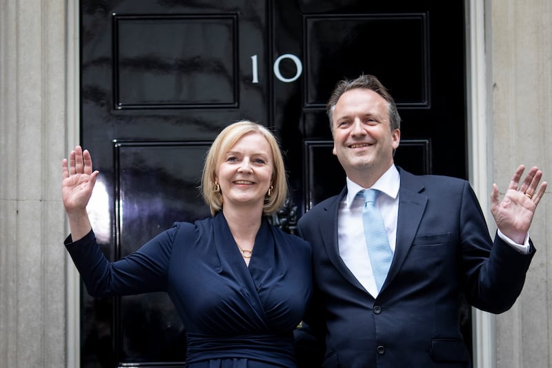 Ms Truss poses with her husband Hugh O'Leary at Downing Street before entering as prime minister for the first time. EPA
