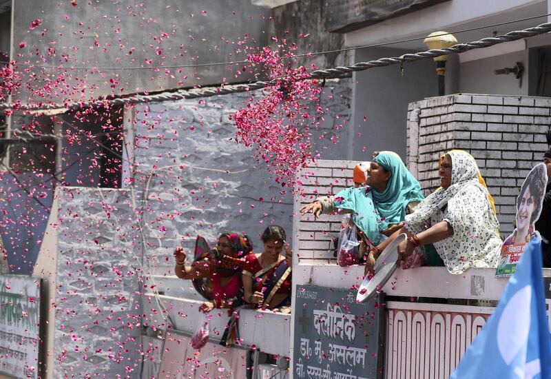 Suporter through red rose to Congress party General secretary Priyanka Vadra in red, after her brother Congress president Rahul Gandhi filed his nomination papers for the upcoming general elections in Amethi, April 10, 2019. 
PHOTO : Jitendra Prakash