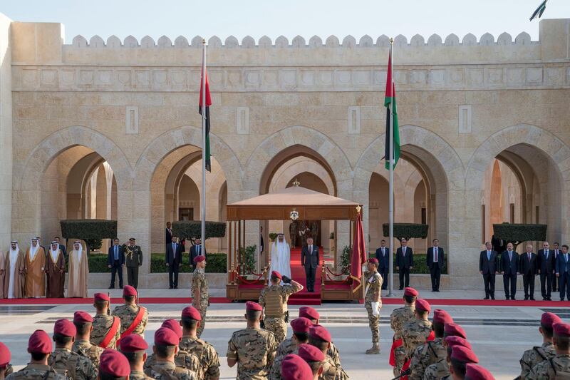 AMMAN, JORDAN - November 20, 2018: HH Sheikh Mohamed bin Zayed Al Nahyan, Crown Prince of Abu Dhabi and Deputy Supreme Commander of the UAE Armed Forces (centre L) and HM King Abdullah II, King of Jordan  (centre R), stand for a National Anthem during a ceremony held to rename the Rapid Intervention/ High Readiness Brigade as the HH Sheikh Mohamed bin Zayed's Rapid Intervention Brigade, at Al Husseiniya Palace.

( Mohamed Al Hammadi / Ministry of Presidential Affairs )
---