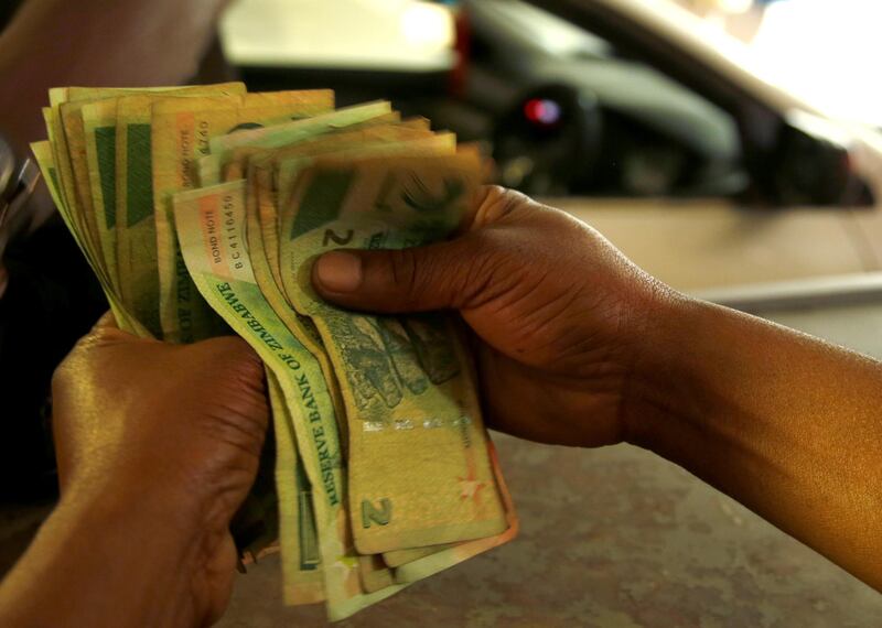 A petrol attendant counts bond notes at a filling station in Harare, Zimbabwe, January 28, 2019, REUTERS/Philimon Bulawayo