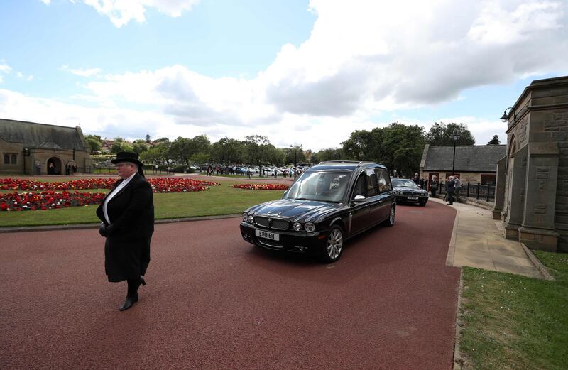 The funeral cortege of British football legend Jack Charlton arrives at West Road Crematorium. AFP