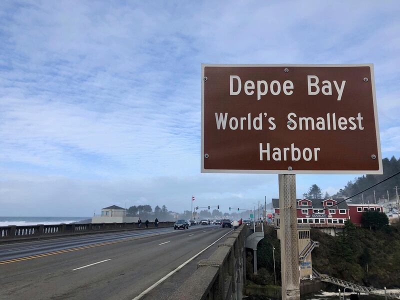 A sign marks the entry to Depoe Bay, Oregon during an extreme high tide that coincided with a big winter storm. AP Photo