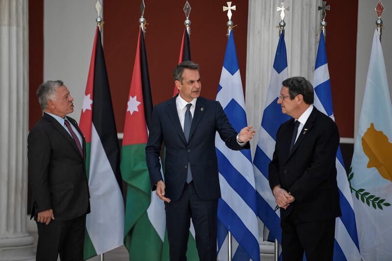 King Abdullah II, Kyriakos Mitsotakis and Nikos Anastasiades talk to one another before their trilateral meeting.