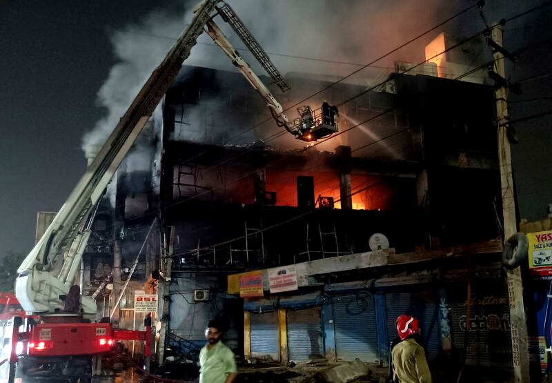 Fire officials try to douse the blaze. AP