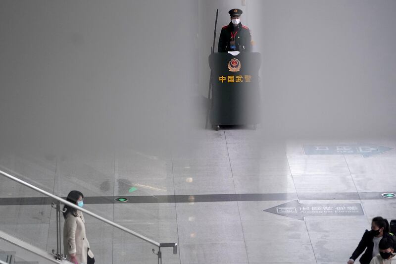 A paramilitary police officer wears a mask at Shanghai railway station in China. Reuters