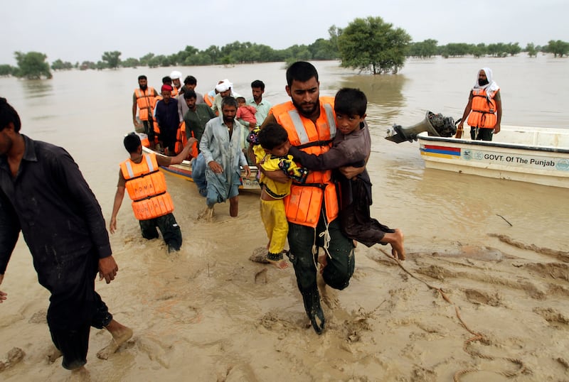 People are moved away from a flood-hit area of the Rajanpur district of Punjab by soliders. AP