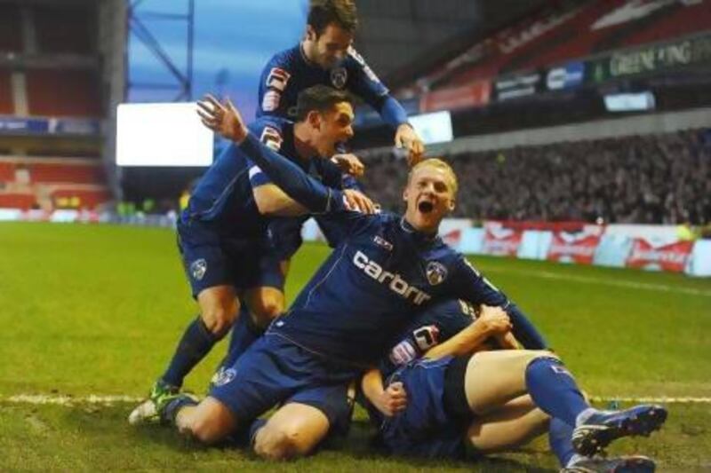 Oldham Athletic players celebrate after scoring in an FA Cup third round match earlier this month. The League One side will host Liverpool on Saturday.