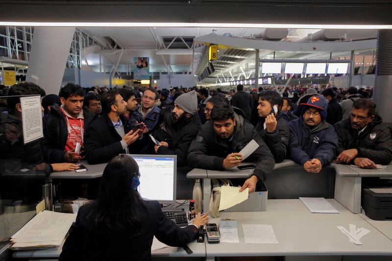 Passengers surround a customer service desk for Air India following a series of delays in the departure area of Terminal 4 at John F. Kennedy International Airport in New York City, U.S. January 7, 2018.  REUTERS/Andrew Kelly