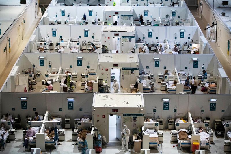 Medical workers and patients are seen in the treatment hall of a temporary hospital in Moscow, Russia. AP Photo