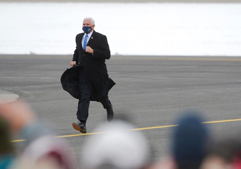 Vice President Mike Pence jogged across the tarmac at the Hibbing, Minn., airport before speaking during a campaign stop there. AP Photo