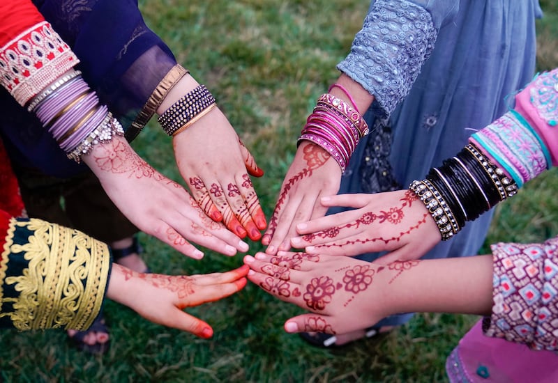 Afghan refugee girls pose with their Henna designed hands to celebrate Eid al-Adha in the US state of Maryland. AP