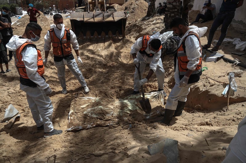 Health workers unearth bodies found at Nasser Hospital in Khan Younis. AFP