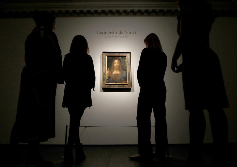 FILE PHOTO:   Members of Christie's staff pose for pictures next to Leonardo da Vinci's "Salvator Mundi" painting which will be auctioned by Christie's in New York in November, in London, Britain October 24, 2017.  REUTERS/Peter Nicholls/File photo   NO RESALES. NO ARCHIVES