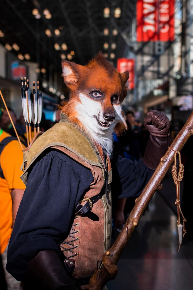An attendee dressed as Disney's 'Robin Hood' poses during New York Comic Con.  AP