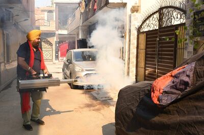 A Congress party worker fumigates an area as part of a prevention campaign against dengue fever in Amritsar last year. AFP