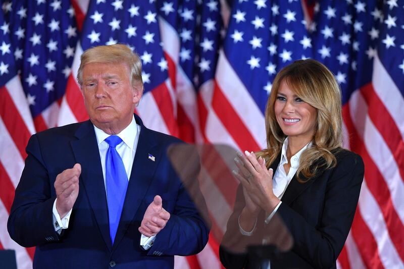 US President Donald Trump claps alongside US First Lady Melania Trump after speaking during election night in the East Room of the White House in Washington, DC, early on November 4, 2020.   AFP
