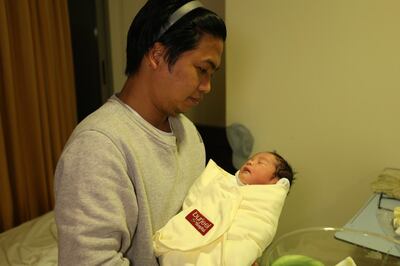 New dad Joven Bautista, 37, holds his son for the first time at Burjeel Hospital in Abu Dhabi. Courtesy: Burjeel