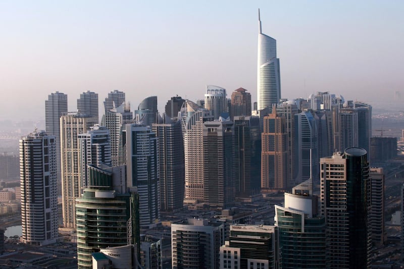 The Almas tower, right, stands above other skyscrapers at the Jumeirah Lake Towers development in Dubai, United Arab Emirates, on Sunday, Dec. 11, 2011. Dubai and its state-owned non-financial companies have $101.5 billion of outstanding debt and may need further financial support to meet those obligations, Moody's said. Photographer: Gabriela Maj/Bloomberg