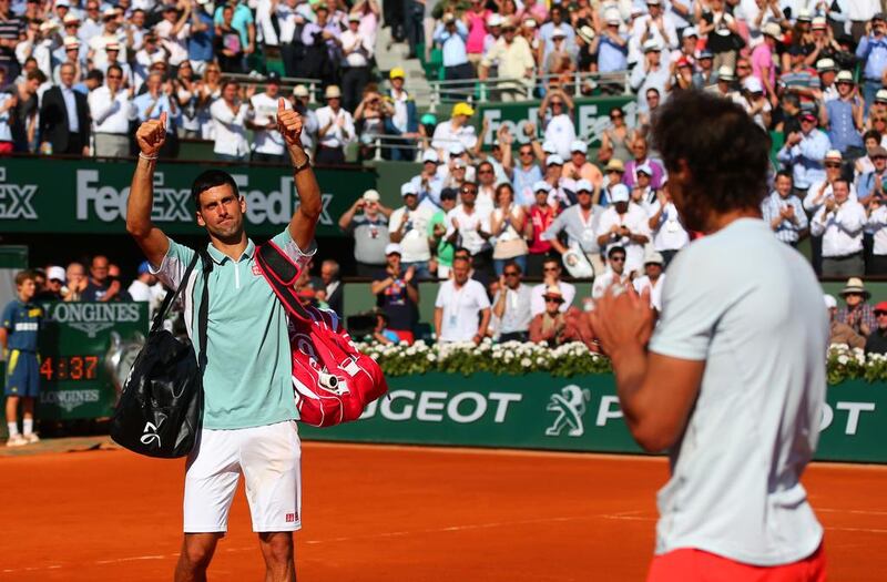 Novak Djokovic of Serbia applauds the fans as he walks off court applauded by Rafael Nadal of Spain after their men's singles semi-final match on day thirteen of the French Open at Roland Garros on June 7, 2013 in Paris, France. Julian Finney/Getty Images