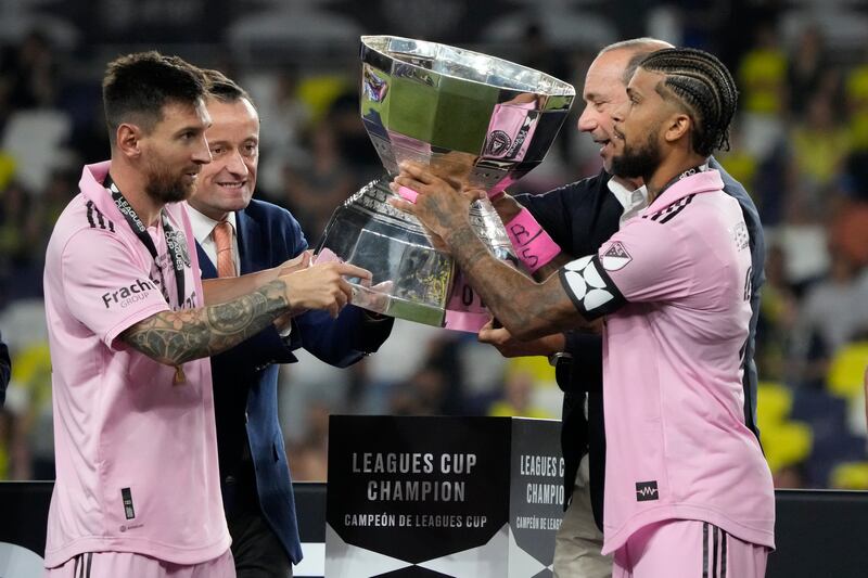 Lionel Messi and defender DeAndre Yedlin are presented with the Leagues Cup trophy. EPA