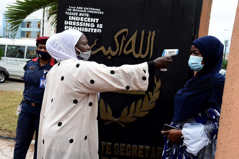 A woman has her temperature checked on entry to Secretariat Community Central Mosque, Alausa in Lagos, on August 7. Pius Utomi Ekpei / AFP