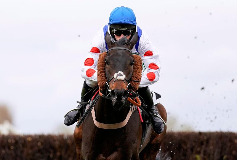 Clan Des Obeaux ridden by Harry Cobden clears the last on their way to winning the Bowl Chase. PA