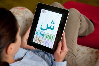 BRA6BC Female student learning Arabic language using education application on iPad tablet computer. Alamy