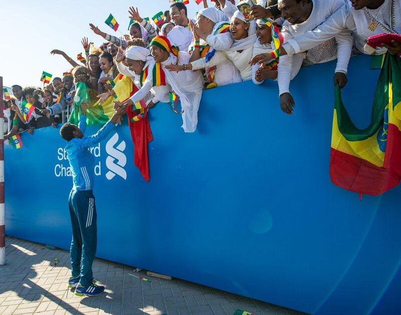 Lemi Berhanu Hayle greets his Ethiopian fans on Friday after winning the 2015 Dubai Marathon. Stephen Hindley / AP