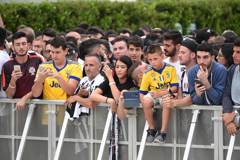 Juventus supporters wait for Ronaldo at the Juventus medical center. AFP